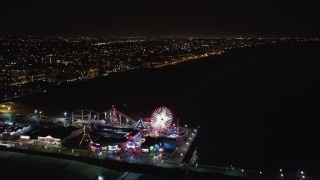LD01_0040 - 5K stock footage aerial video approach and fly over Santa Monica Pier, California at night