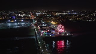 LD01_0041 - 5K aerial stock footage tilt to reveal and approach Santa Monica Pier, California at night