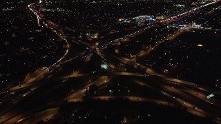 LD01_0044 - 5K stock footage aerial video pan across freeway at night to reveal interchange, West Los Angeles, California