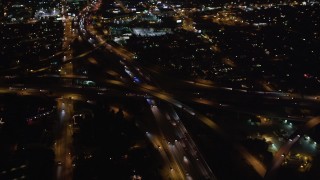 LD01_0046 - 5K stock footage aerial video orbit a freeway interchange at night in West Los Angeles, California