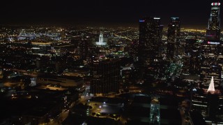 LD01_0075 - 5K aerial stock footage of city hall, and reveal skyscrapers at night in Downtown Los Angeles, California