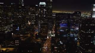 LD01_0076 - 5K stock footage aerial video pan across Downtown Los Angeles, California skyscrapers at night