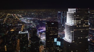 LD01_0080 - 5K stock footage aerial video fly over skyscrapers to approach Staples Center at night Downtown Los Angeles, California