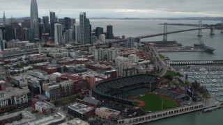 PP0002_000016 - 5.7K stock footage aerial video flying by AT&T Park, tilt to city skyline in background, Downtown San Francisco, California