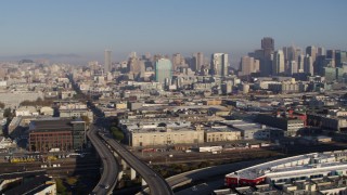 PP0002_000092 - 5.7K stock footage aerial video ascend by freeway and pan across city to reveal skyline, Downtown San Francisco, California