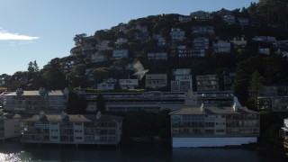 PP0002_000130 - 5.7K stock footage aerial video ascend by waterfront condos to a view of hillside neighborhoods in Sausalito, California