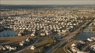 PP001_003 - HD aerial stock footage of flying by suburban tract homes at sunset in Joliet, Illinois