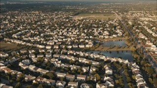 PP001_004 - HD aerial stock footage video of flying over suburban neighborhoods at sunset in Joliet, Illinois