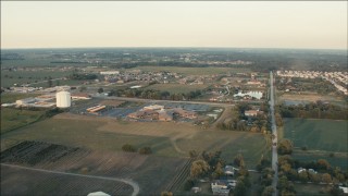 PP001_007 - HD aerial stock footage of approaching a school near rural neighborhoods at sunset in Homer Glen, Illinois