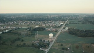 PP001_009 - HD aerial stock footage fly over farmland to approach homes at sunset in Homer Glen, Illinois