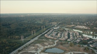 PP001_011 - HD aerial stock footage of suburban homes and rows of power lines at sunset, Orland Park, Illinois