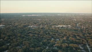 PP001_013 - HD aerial stock footage of suburban neighborhoods and trees at sunset in Palos Heights, Illinois