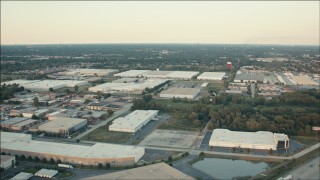 PP001_015 - HD aerial stock footage of flying over large warehouse buildings at sunset, Alsip, Illinois