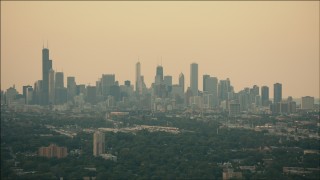 PP001_016 - HD aerial stock footage of the hazy skyline at sunset in Downtown Chicago, Illinois
