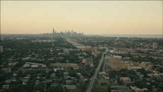 PP001_017 - HD stock footage aerial video of the Downtown Chicago skyline at sunset seen from Englewood, Illinois