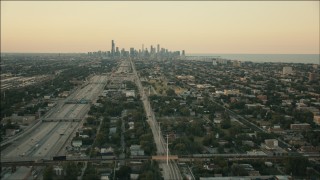 PP001_019 - HD aerial stock footage of the city skyline at sunset seen from freeway on South Side, Downtown Chicago, Illinois