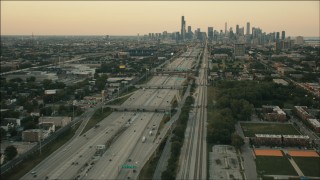PP001_022 - HD aerial stock footage of following freeway and train tracks at sunset to approach Downtown Chicago, Illinois