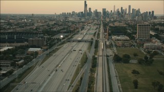 PP001_023 - HD aerial stock footage of a commuter train heading toward Downtown Chicago at sunset, Illinois