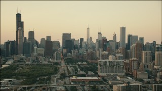 PP001_025 - HD aerial stock footage tilt from freeway interchange to reveal the skyline at sunset, Downtown Chicago, Illinois