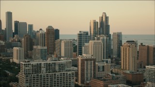PP001_026 - HD aerial stock footage of flying by city skyscrapers at sunset in Downtown Chicago, Illinois
