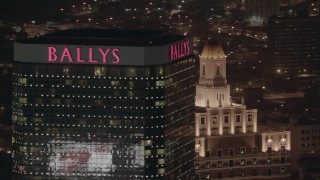 PP003_022 - HD stock footage aerial video of passing the top of a hotel and casino at night in Atlantic City, New Jersey