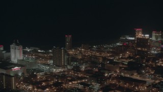 PP003_028 - HD stock footage aerial video pan across hotels and casinos on the shore at night in Atlantic City, New Jersey