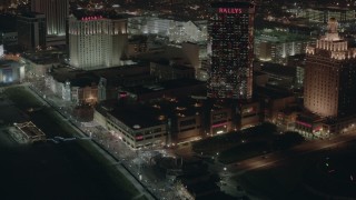 PP003_031 - HD stock footage aerial video of tilting from hotels and casinos to the park and boardwalk at night in Atlantic City, New Jersey