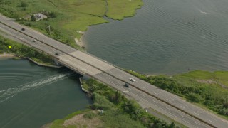 PP003_041 - HD stock footage aerial video of a fishing boat sailing under a bridge in Seaford, New York