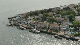PP003_042 - HD stock footage aerial video of upscale, waterfront homes with docks, Merrick, New York