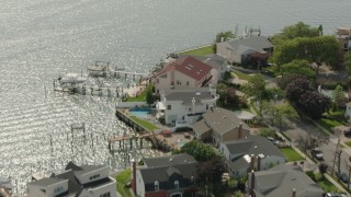 PP003_043 - HD stock footage aerial video of flying over upscale, waterfront homes and a bay in Merrick, New York
