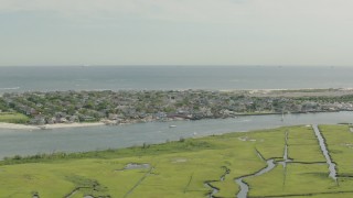 PP003_049 - HD stock footage aerial video of a coastal community across a channel and marshes, Point Lookout, New York