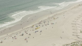PP003_051 - HD stock footage aerial video of approaching sunbathers on the beach, Lido Beach, New York
