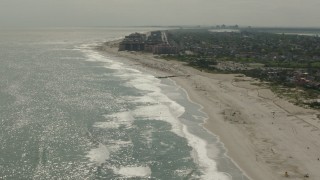 PP003_052 - HD stock footage aerial video of tilting from sunbathers on the beach to the Lido Beach coastal community in New York