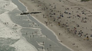 PP003_053 - HD stock footage aerial video of approaching sunbathers on the beach, Long Beach, New York