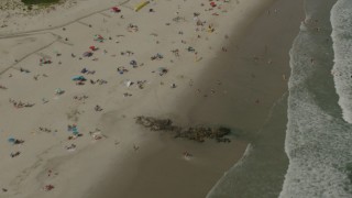 PP003_054 - HD stock footage aerial video of a reverse view of sunbathers on the beach in Long Beach, New York