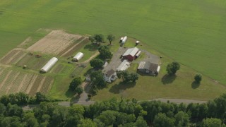 PP003_063 - HD stock footage aerial video of a farm with greenhouses, red barn and green fields, Jackson, New Jersey