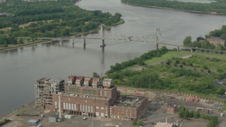PP003_083 - HD stock footage aerial video orbit power plant to reveal a bridge spanning the river in Burlington, New Jersey