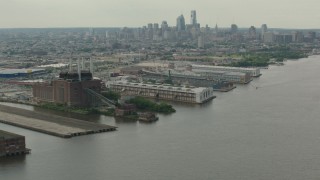 PP003_089 - HD stock footage aerial video flyby piers and riverfront factory with a view of the Downtown Philadelphia skyline, Pennsylvania