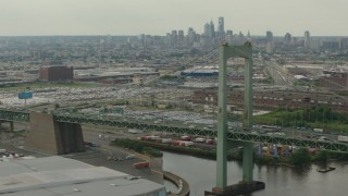 PP003_090 - HD stock footage aerial video of a view of Downtown Philadelphia skyline, seen while passing piers and Walt Whitman Bridge, Pennsylvania