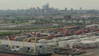 PP003_092 - HD stock footage aerial video of the Downtown Philadelphia skyline seen while passing containers at a shipping port, Pennsylvania