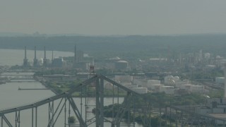 PP003_102 - HD stock footage aerial video ascend over the Commodore Barry Bridge to reveal an oil refinery in Chester, Pennsylvania