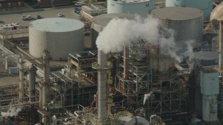 PP003_104 - HD stock footage aerial video of steam venting from an oil refinery structure in Chester, Pennsylvania