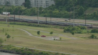 PP003_106 - HD stock footage aerial video of a commuter train running by the river in Wilmington, Delaware