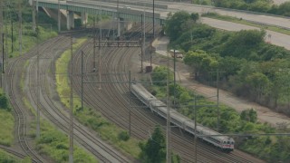 PP003_108 - HD stock footage aerial video track a commuter train approaching an overpass in Wilmington, Delaware