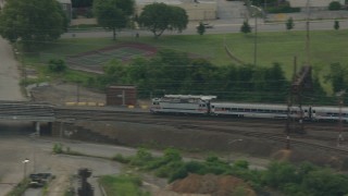 PP003_111 - HD stock footage aerial video of tracking a commuter train cruising through Wilmington, Delaware