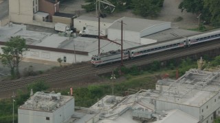 PP003_113 - HD stock footage aerial video tracking a passenger train cruising through Wilmington, Delaware
