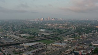 PVED01_003 - 4K aerial stock footage of Downtown New Orleans skyline from Gentilly at sunrise, Louisiana