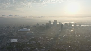 PVED01_008 - 4K aerial stock footage of Downtown New Orleans and Superdome with view of rising sun, Louisiana