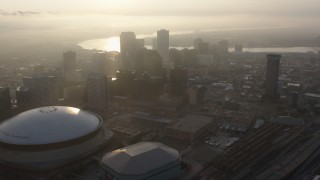 PVED01_009 - 4K aerial stock footage tilt to reveal Superdome and Downtown New Orleans skyscrapers at sunrise, Louisiana