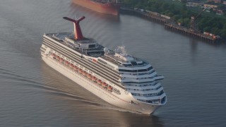 PVED01_012 - 4K aerial stock footage of Carnival Cruise ship sailing the Mississippi River at sunrise, New Orleans, Louisiana